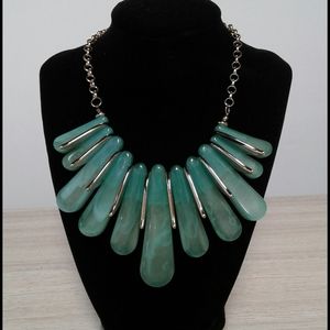 A statement necklace in aqua and gold tone
